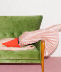 woman face down on the couch with pink pleated skirt | ampersand branding