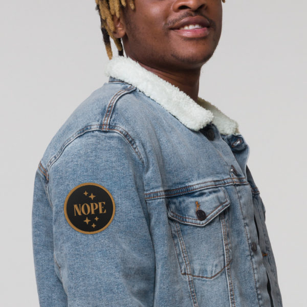 nope embroidered-patches-black-front in sleeve of jacket | ampersand branding studio