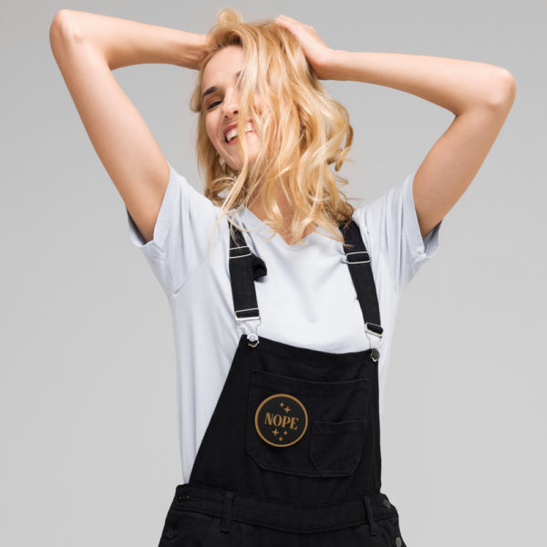 nope embroidered-patches-black-front on front of overalls | ampersand branding studio