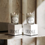 two candle boxes with candles on top